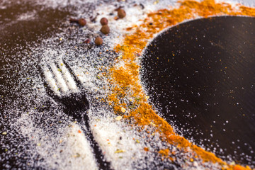 Top View Spices and Herbs on the dark table with space for text.