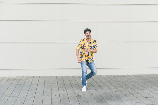 Young Man Wearing Flat Hat And Aloha Shirt, Having Fun