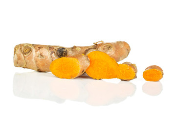 Group of one whole three slices of ripe bright turmeric rhizome isolated on white background