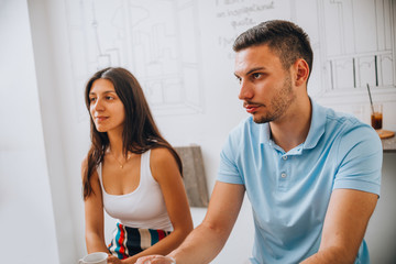 Fototapeta premium Cheerful couple drinking wine in cafe and having conversation