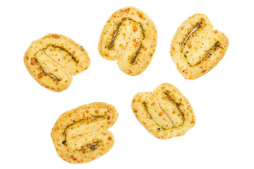 Group of five whole fresh baked savory cheese palmier flatlay isolated on white background