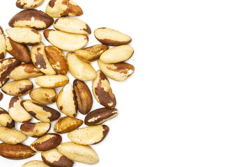 Lot of whole unshelled brazil nut copyspace on right flatlay isolated on white background