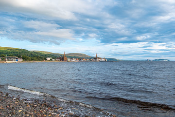 Fototapeta na wymiar Scottish Town of largs Looking Across the Bay to the Town before sunset as the as the sun relects on the sky and the town.
