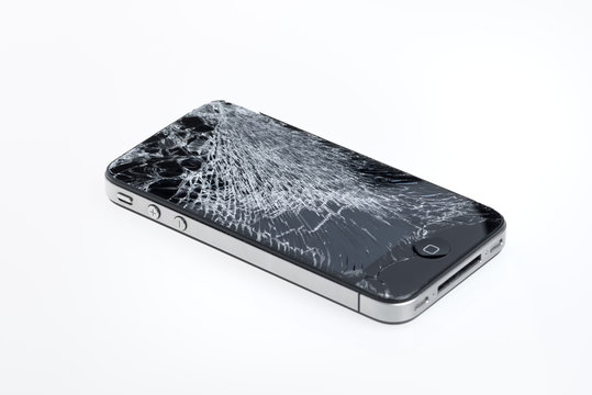 Kiev, Ukraine - January 25, 2013: Studio shot of Apple iPhone 4 with a broken screen. Apple iPhone 4 developed by Apple inc. in June, 2010.