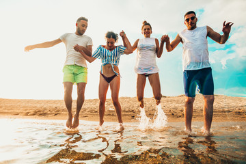 Diverse beach summer friends fun jump shot concept