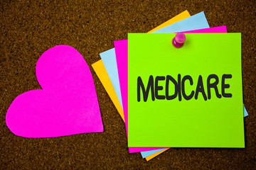 Handwriting text writing Medicare. Concept meaning Federal health insurance for people above 65 or with disabilities Thumb pinned sticky cards love heart messages card remember sign board