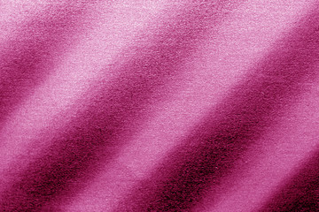 Plastic glittering texture in pink tone.