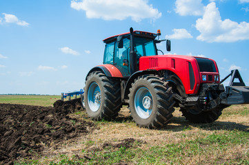 Fototapeta premium Tractor while plowing