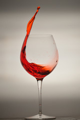 wine glass splashing on background