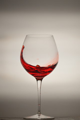 wine glass splashing on background
