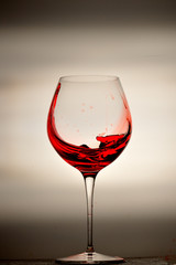 wine glass splashing on background