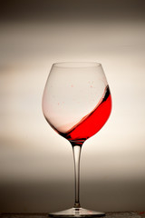 wine glass splashing on background