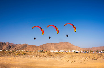 Muscat,Oman-26th December2018. A paragliding competition with three gliders flying in a row. Extreme sports 