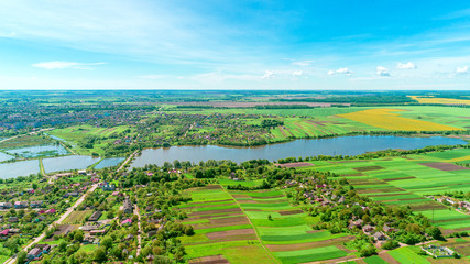 Top view of rural landscape on sunny spring day. House and green field. Drone photography