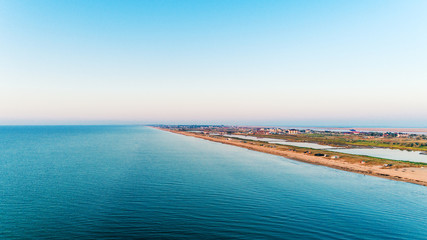 Aerial view of sun rising over sea.