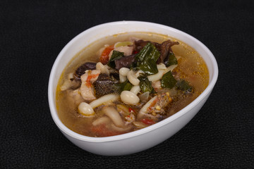 Thai style soup with meat and mushrooms