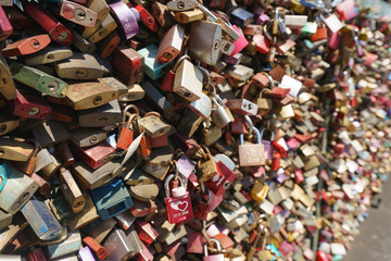 Photo of  love locks. Lovers hang licks on a bridge in the city. Natural bright background.