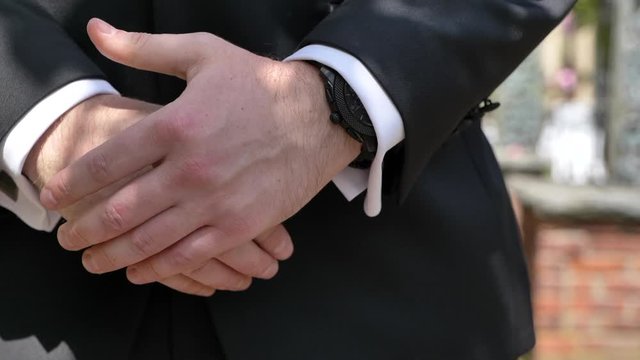 Man in suit hands fidgeting in close up