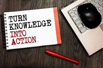 Conceptual hand writing showing Turn Knowledge Into Action. Business photo showcasing Apply what you have learned Leadership strategies Bluetooth mouse on keyboard words red pen on wooden deck
