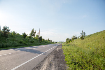 Fototapeta na wymiar speed highway through the field. asphalt-paved road