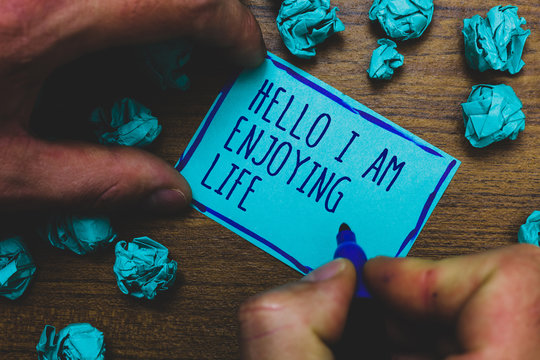 Writing Note Showing Hello I Am Enjoying Life. Business Photo Showcasing Happy Relaxed Lifestyle Enjoy Simple Things Foggy Hand Hold Marker Drawn Blue Notepad Paper Lump On Wooden Floor