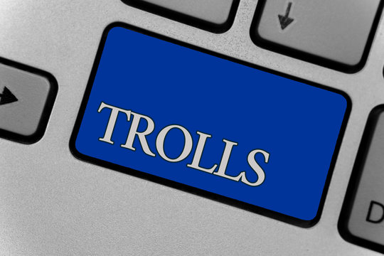 Conceptual hand writing showing Trolls. Business photo text Online troublemakers posting provocative inflammatory messages Keyboard grey key silver laptop create computer keypad notebook