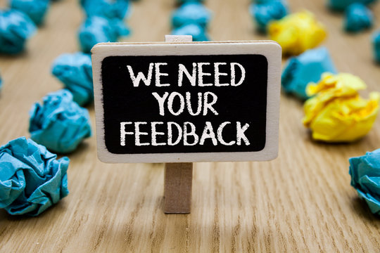Text sign showing We Need Your Feedback. Conceptual photo Give us your review thoughts comments what to improve Paperclip hold written chalkboard behind paper lumps on woody deck