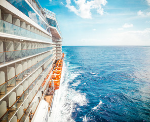 Side view of cruise ship on the blue sky background with copy space, blue tone