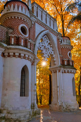 Stone gate in the autumn Park. The sun's rays Shine through the leaves. Tsaritsyno, Moscow.