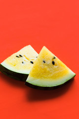 cut off triangular slices of ripe yellow watermelon on white background
