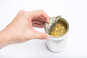 hand pull to open peas in brine canned , canned food isolated on white background