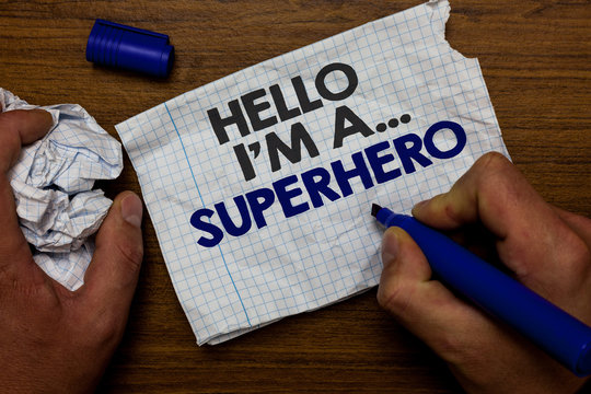 Word writing text Hello I am A ... Superhero. Business concept for Special powers Cartoon character Customs strenght Hand hold paper lob and blue marker wooden base with torn white written page