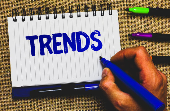Conceptual hand writing showing Trends. Business photo showcasing General projected directions of something according to time Notepad marker creative ideas mat black shadow white papers