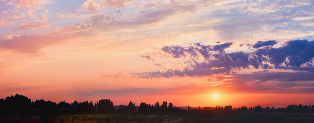 Light through the clouds against the backdrop of an exciting, vibrant sky at sunset. panorama, nature composition, nature background picture, copy space