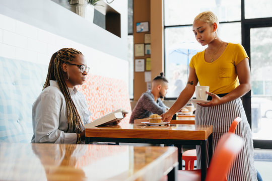 Waitress serving customer her order