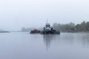 Pripyat River. small ship. descent along the river in large piles of stones on a ferry.