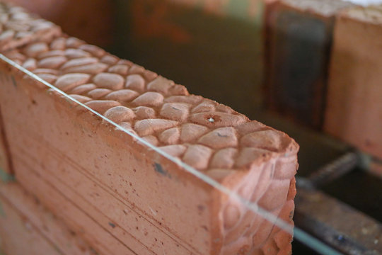 Builder builds a brick stove, builder tools. Trowel with a solution in a bucket