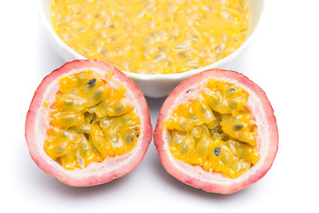 Half cut passion fruit and passion fruit juice in a bowl isolated on white background, sour fruit, fruit background, healthy food