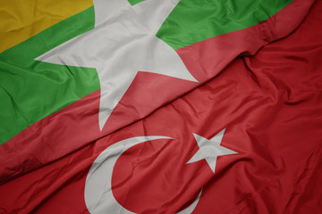 waving colorful flag of turkey and national flag of myanmar.