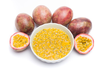 Half cut passion fruit and passion fruit juice in a bowl isolated on white background, sour fruit, fruit background, healthy food