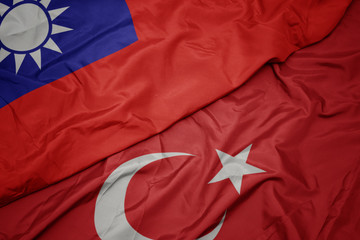 waving colorful flag of turkey and national flag of taiwan.