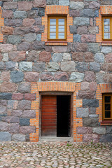 Fototapeta na wymiar door and windows of an old stone building