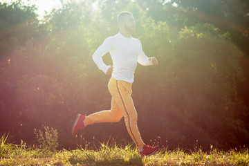 Fototapeta na wymiar young guy jogging outdoors