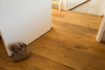 Door stopper on laminate floor.Door stopper to prevent bumps while opening doors.