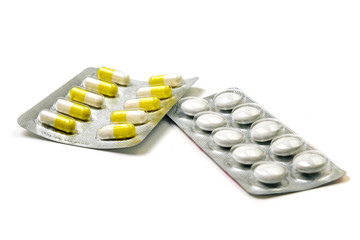 yellow and white tablets in a package isolated on a white background