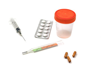 pills, syringe, thermometer and medical items on white background.