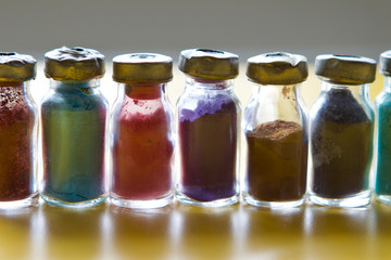 Colour pigment in smal glass bottles in a row