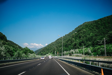 road in mountains summer forest sky
