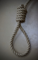 A rope noose on a beige floor