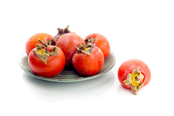 Persimmon on a green plate